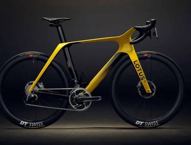 Client reference photo — yellow performance road bike, studio side profile